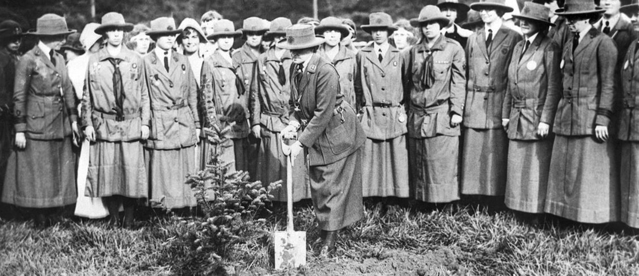 Juliette Gordon Low plants a memorial evergreen sapling at the 3rd International World Conference, 1924