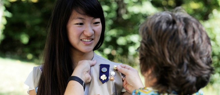 A Girl Scout receives her Gold Award.