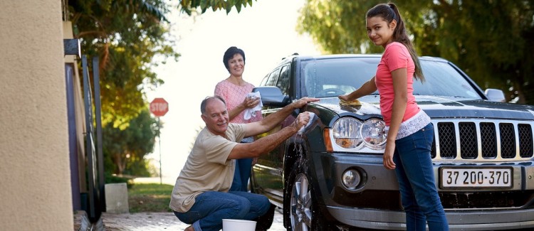 Girl helping parents with car wash