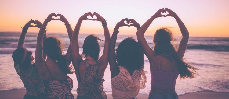 Five girls celebrating Galentine's Day and friendship at the beach