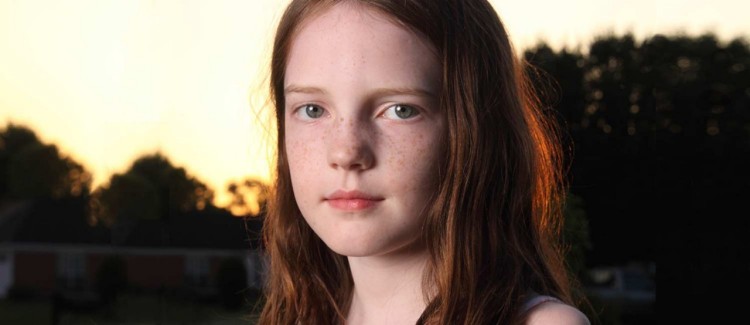 Girl with red hair at sunset