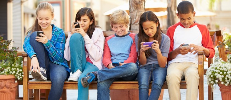 teenagers texting on their cell phones