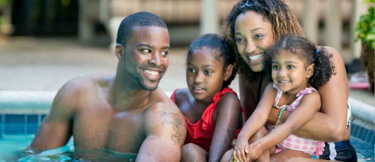 family with two girls in a swimming pool