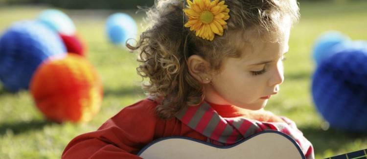 little girl playing guitar