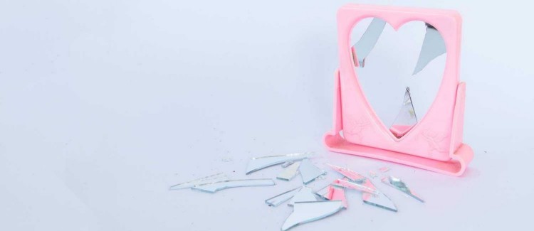 broken mirror to illustrate body image issues in a young girl