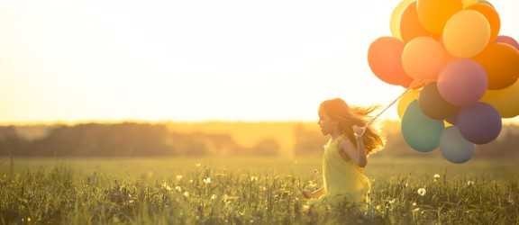 little girl playing in a field