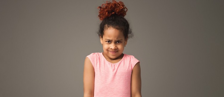 young girl in pink shirt looking frustrated that parent won't solve her problems