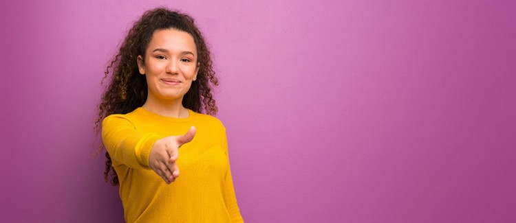 Girl extending arm to shake hands at a job interview