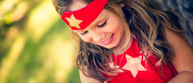 Little girl daughter dressed up as a superhero like Wonder Woman