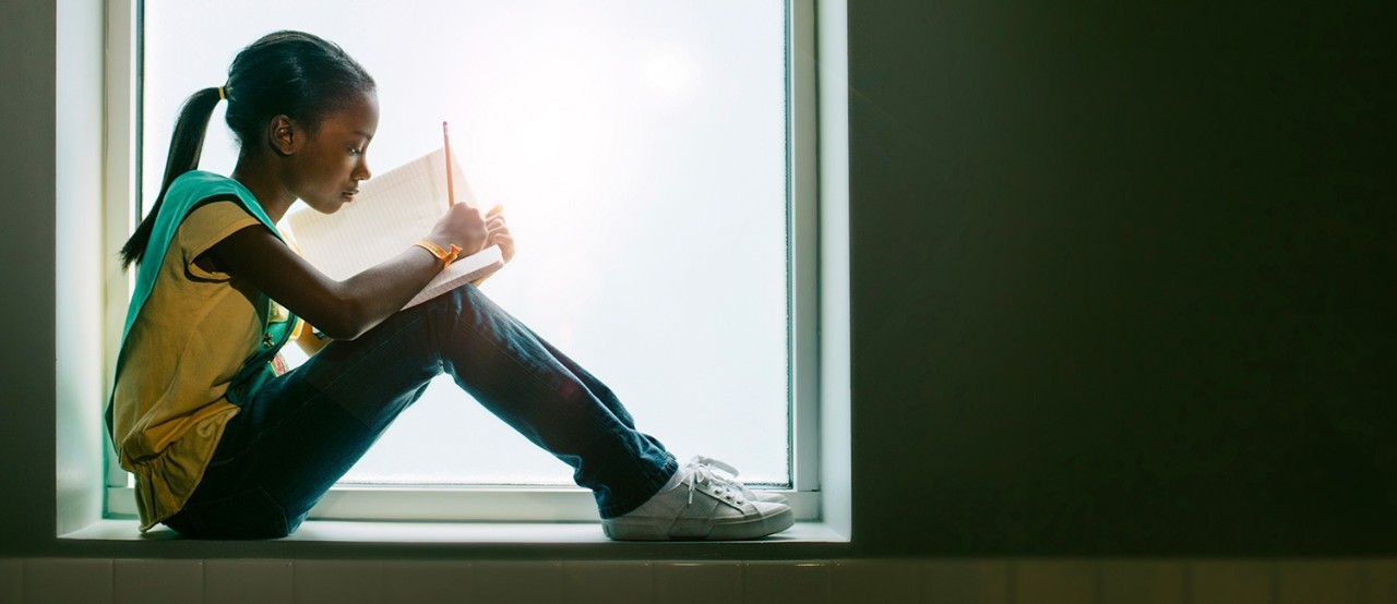 Girl Scout Junior reading a book