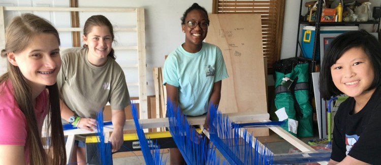 Girl Scouts work together to construct Zipper sensory tool for kids with autism. 